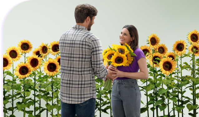 A couple holding a bouquet of sunflowers