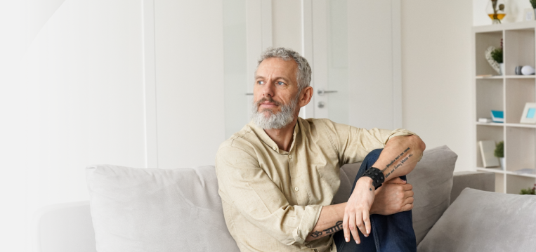 A thoughtful man sitting on a couch