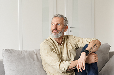 A thoughtful man sitting on a couch