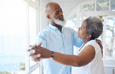 Senior couple dancing seaside