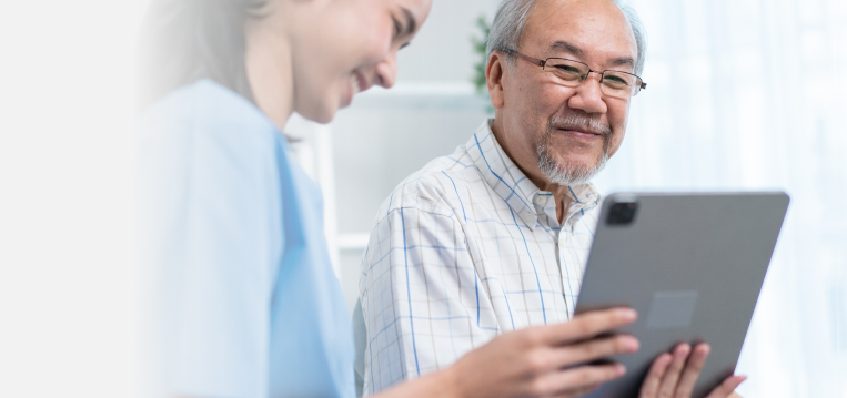 An older man is being medically consulted by a young nurse