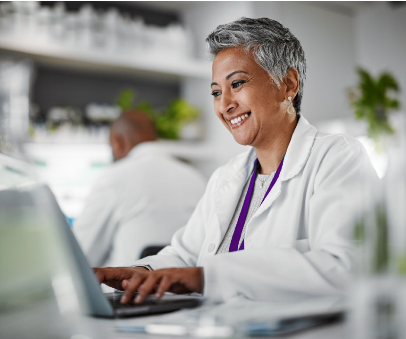 A smiling female scientist in a laboratory