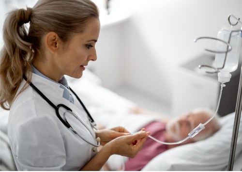 A health care provider administering an infusion medication to a patient